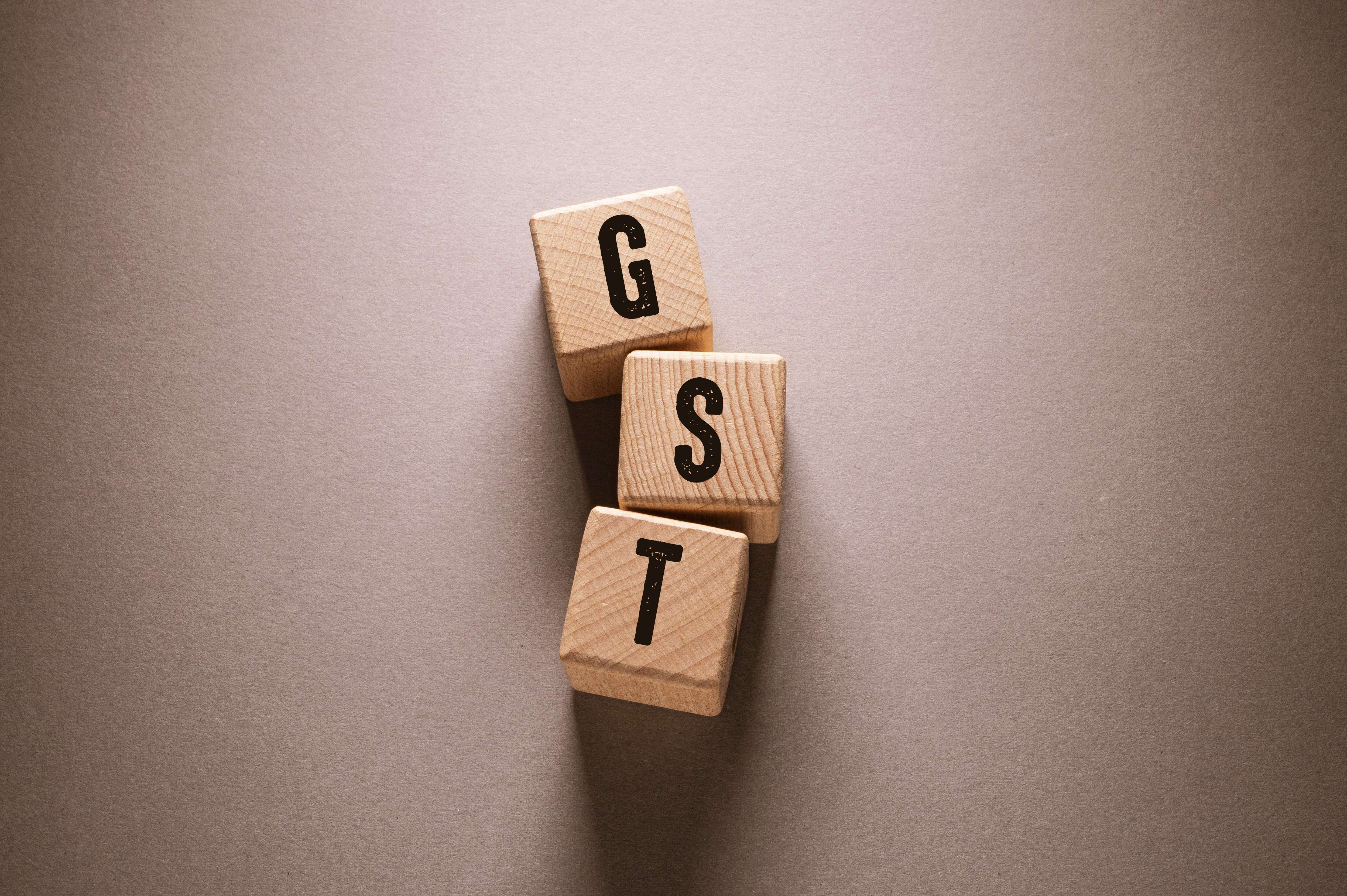 1735798448vecteezy-gst-word-with-wooden-cubes(1).jpeg